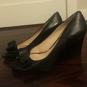 black leather peep toe wedge heels.